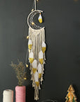 Crescent moon dream catcher for wall hanging on white background.