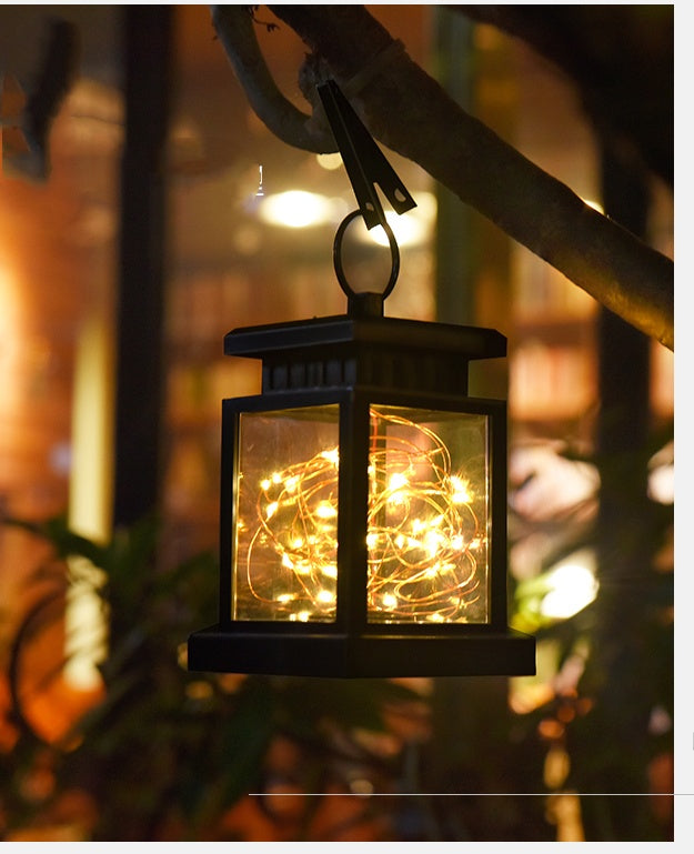 An image of the light suspended by its handle or hook. This shot should show the lamp in its full "hanging" state, highlighting the lantern design and how it would naturally look on a balcony or garden branch.