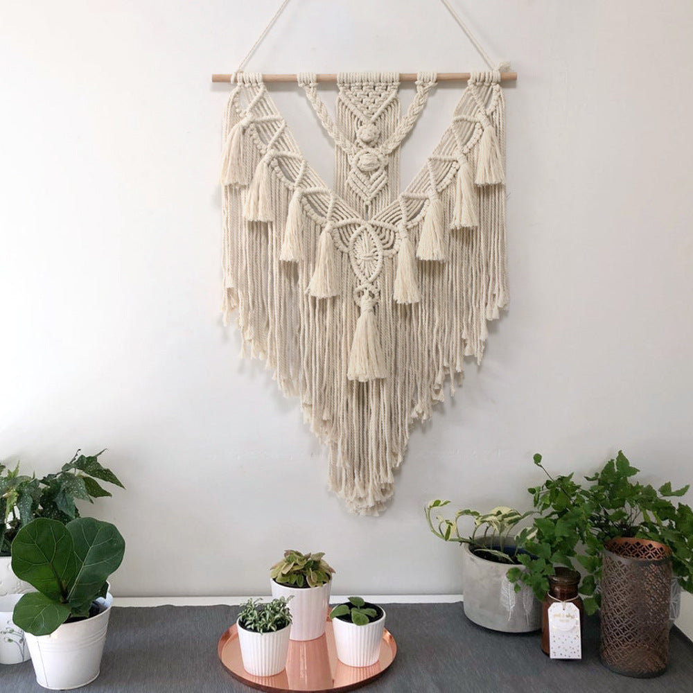 Hand-woven pendant home decor hanging on white background.