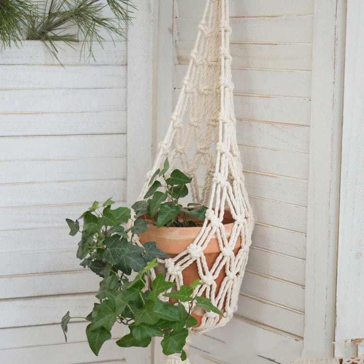A full-length vertical shot showing the macramé hanger suspended. Place a medium-sized pot with a lush Spider Plant inside to demonstrate the "Net Bag" functionality.